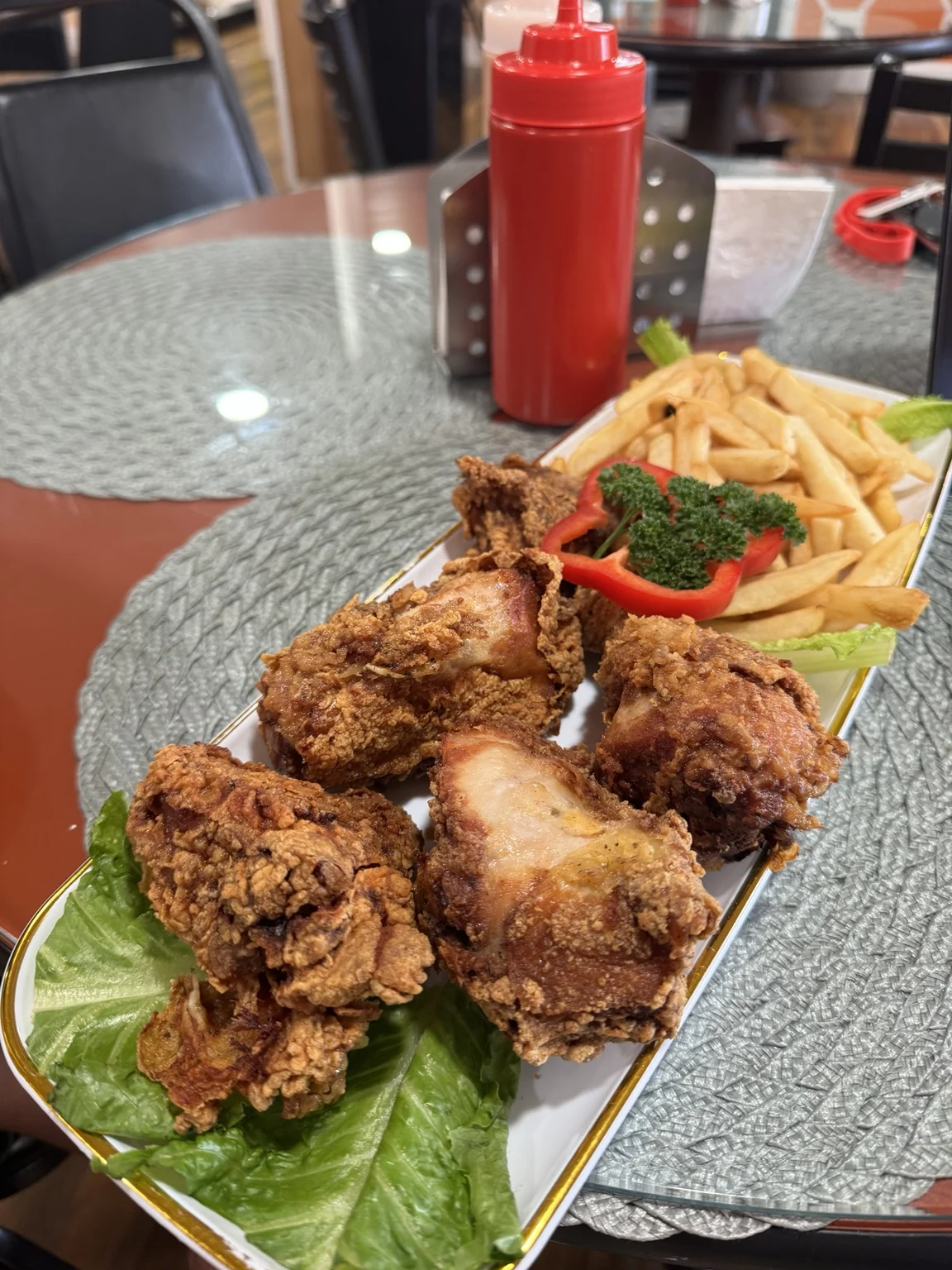 Fried chicken and french fries served inside ROXI’S Fried Chicken